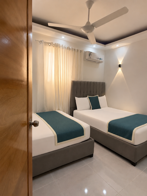 Twin Room desde la entrada, dos camas con acento turquesa